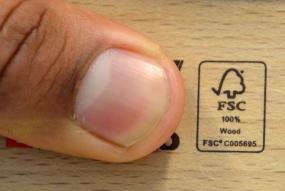Small FSC label with finger pointing at it