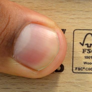 Small FSC label with finger pointing at it